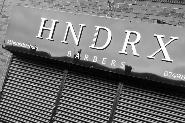 The HNDRX Barbers sign above the shutters